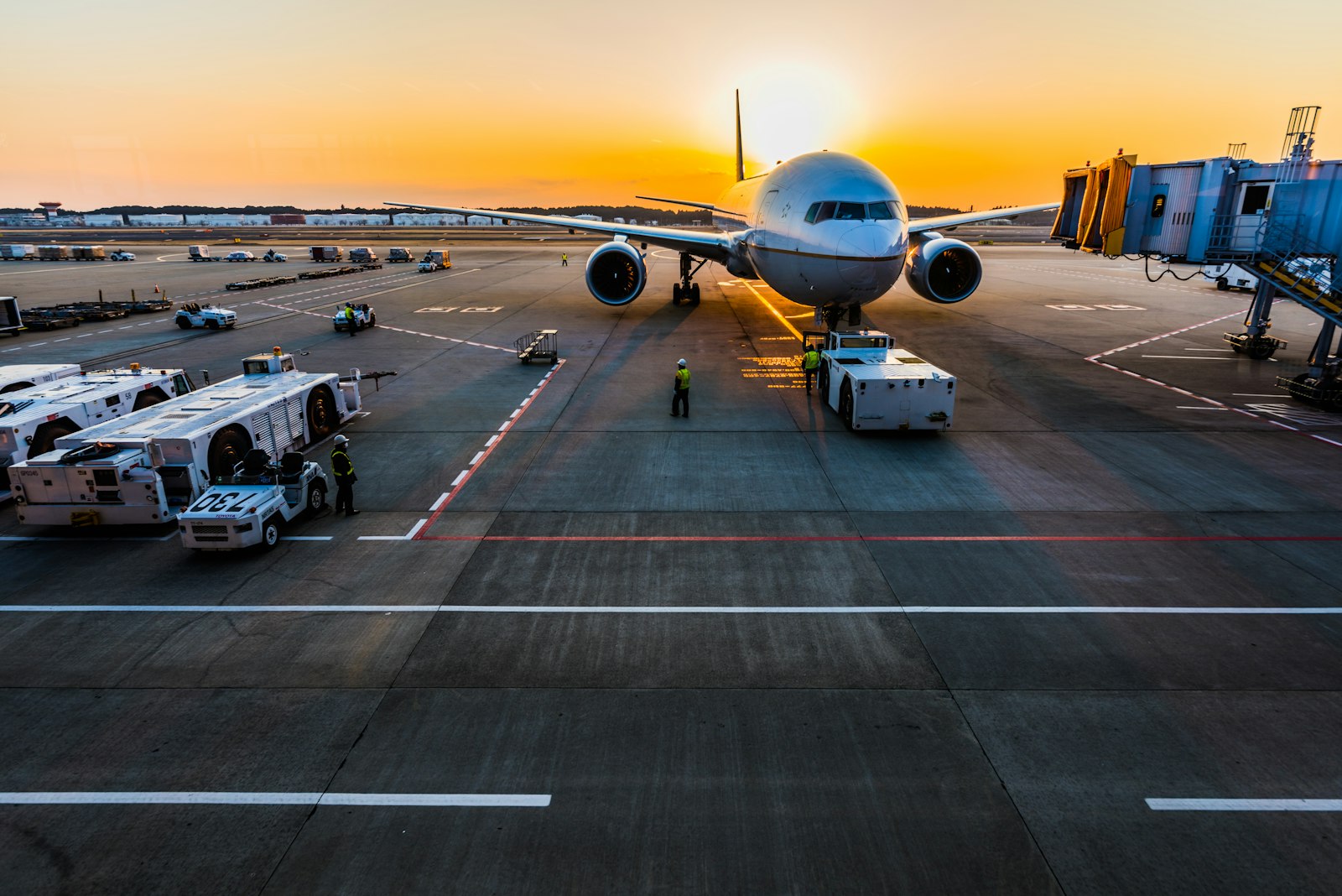Airport apron with ground support vehicles at dusk